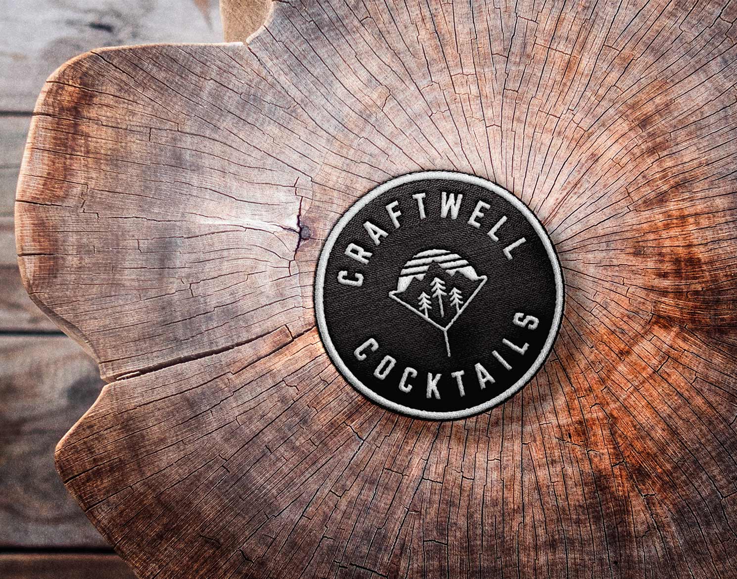 Craftwell Cocktails logo embroidered patch on wood stump