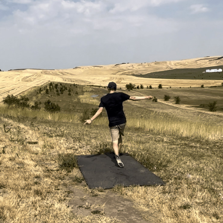 Harrison Sabean playing disc golf.